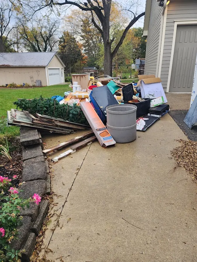 Dumpster being loaded with debris for 3 Yard Dumpster Rental in Mitchellville